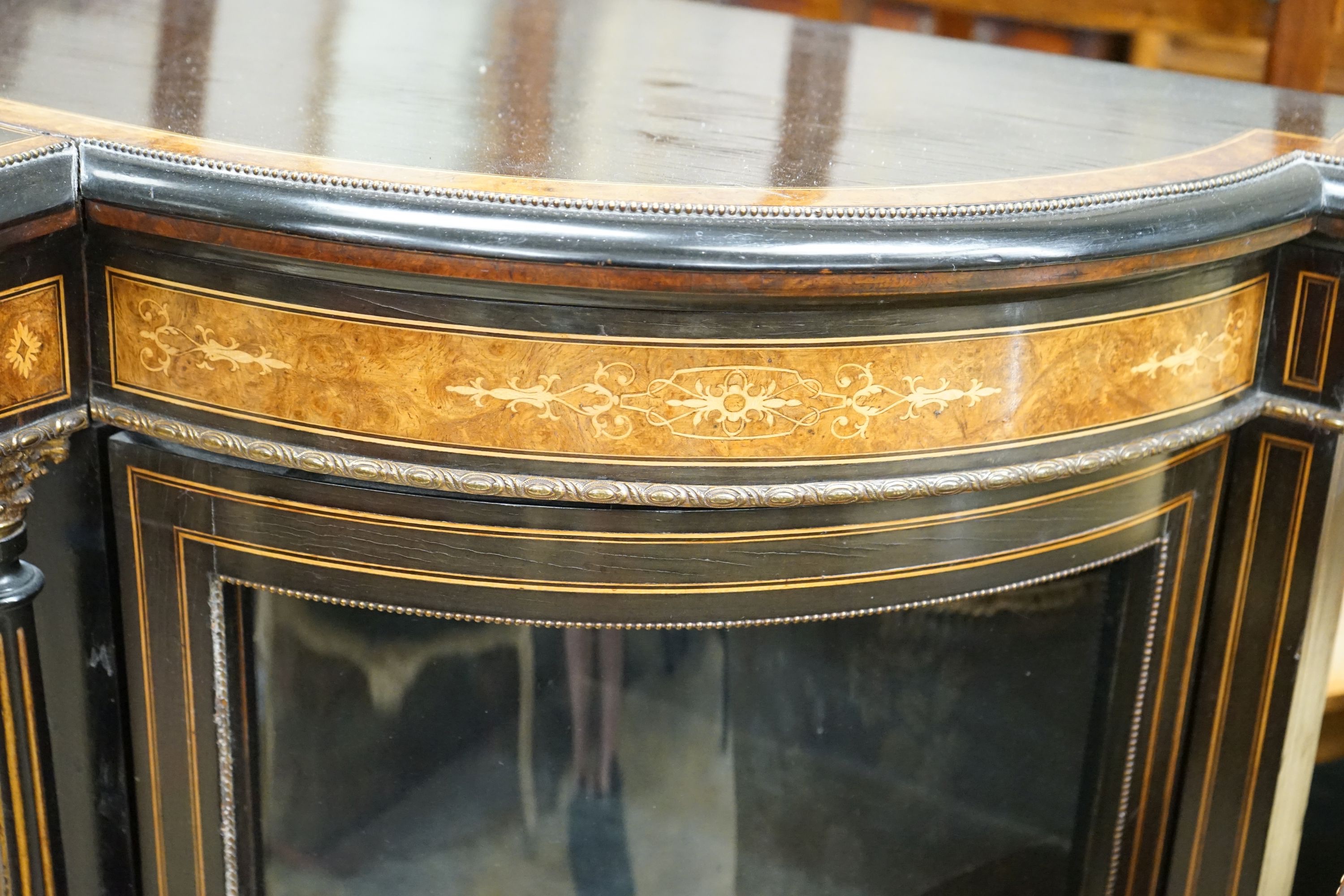 A late Victorian ebonised and amboyna banded credenza, with inset Sevres style porcelain panel, width 154cm, depth 45cm, height 107cm